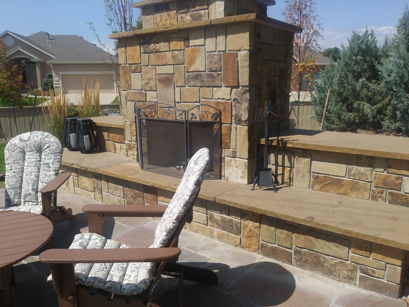 Outdoor fireplace with flat stone hearth and flat stone patio.