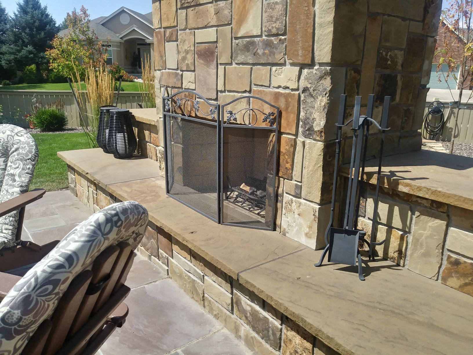 Outdoor Fireplace with large stone chimney and flat stone hearth