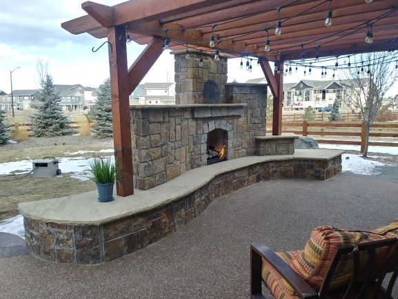 Exterior Fireplace with pergola on top.