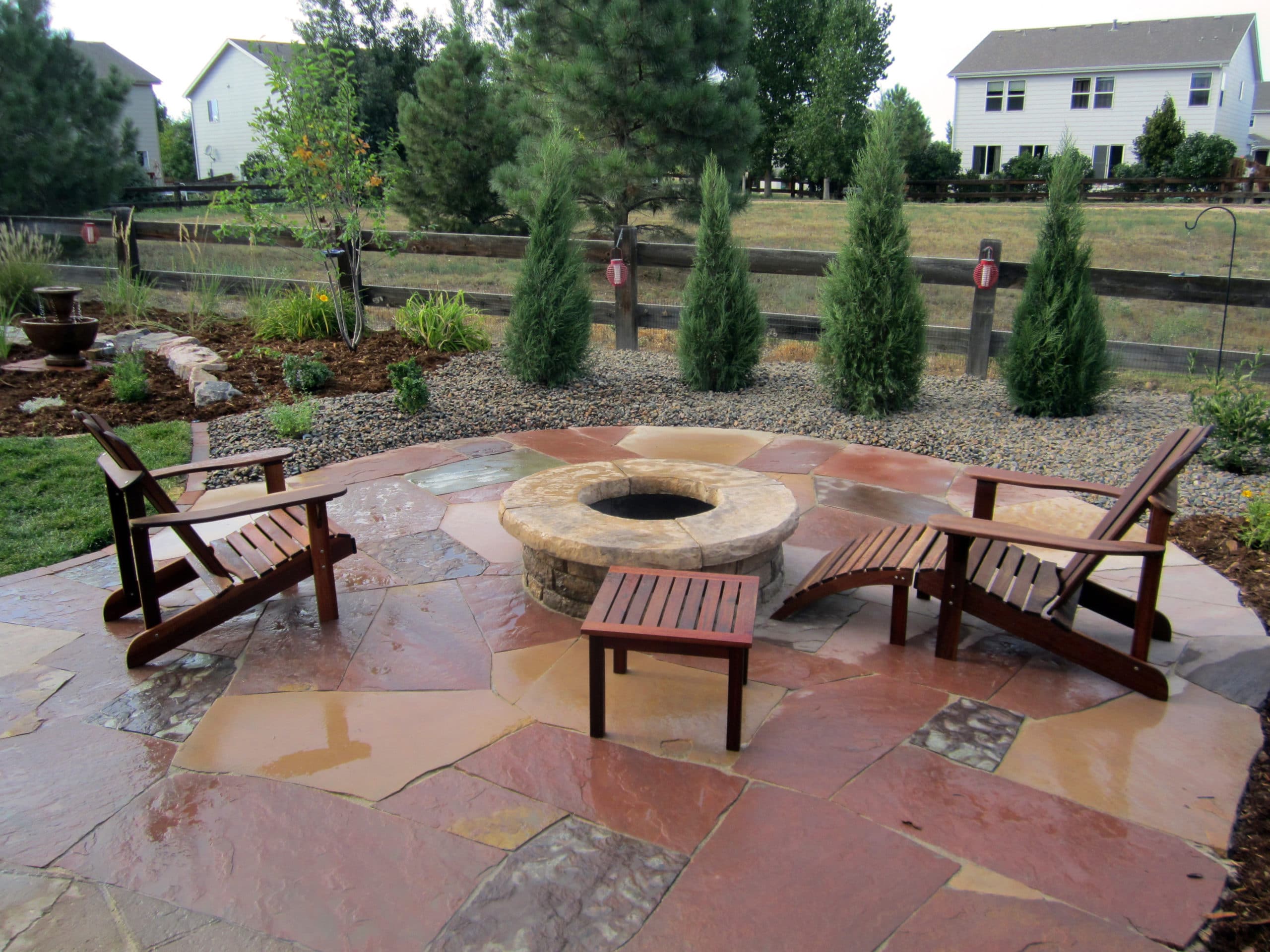 Flat stone patio with flat stone fire pit with seating area.