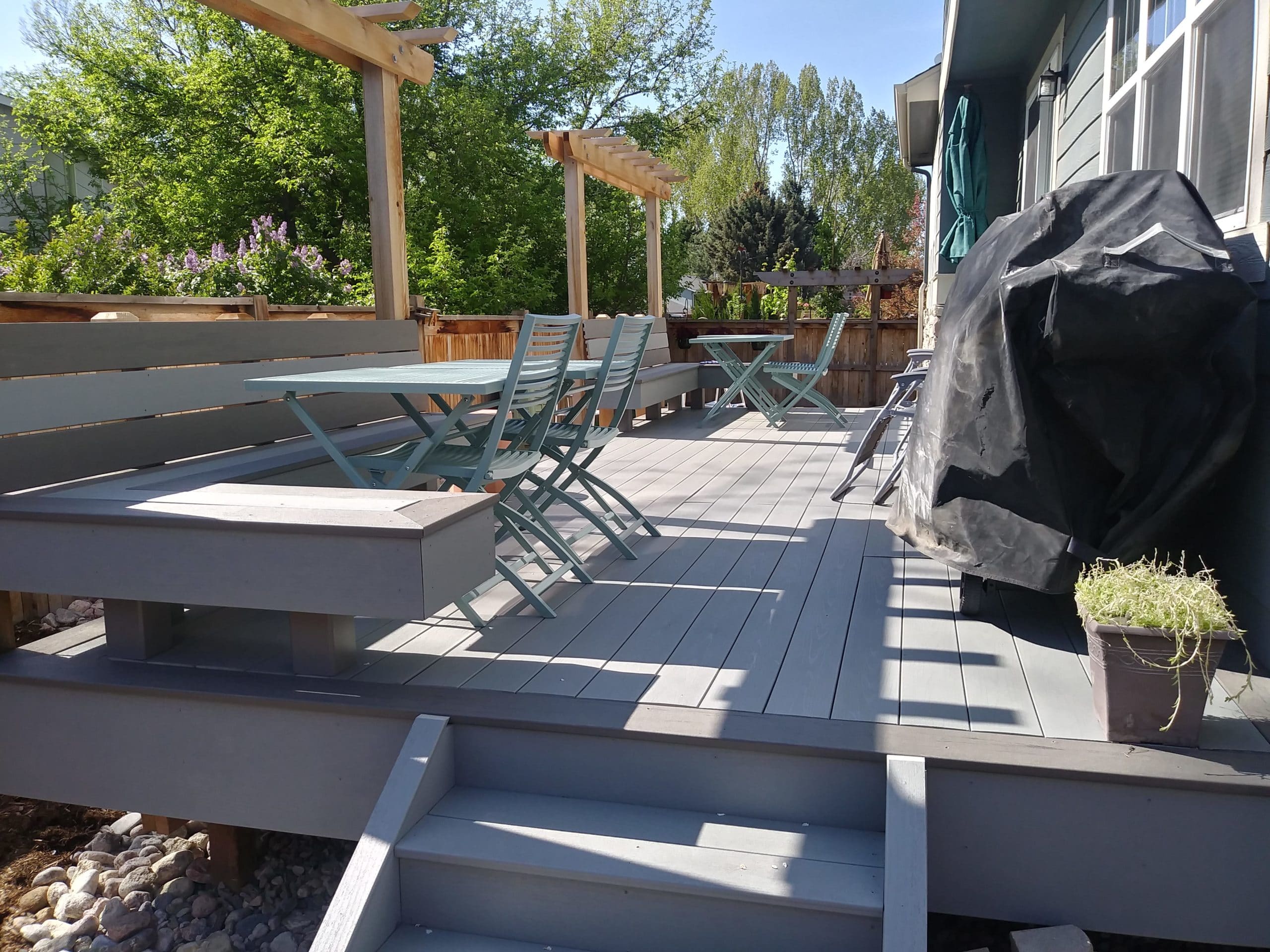 Composite deck with built in bench seats and small pergolas over top.