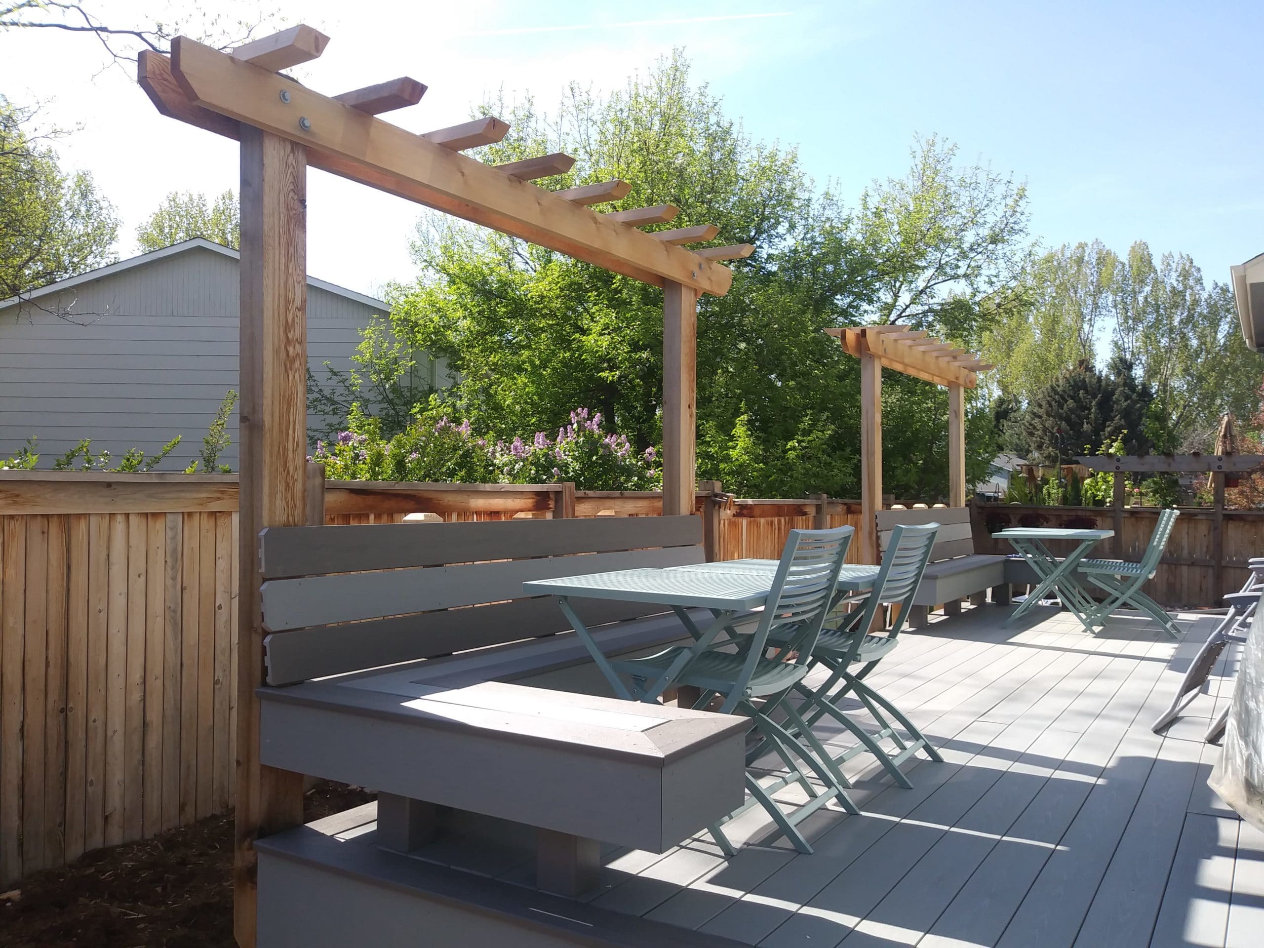 Composite deck with built in bench seats and small pergolas over top.