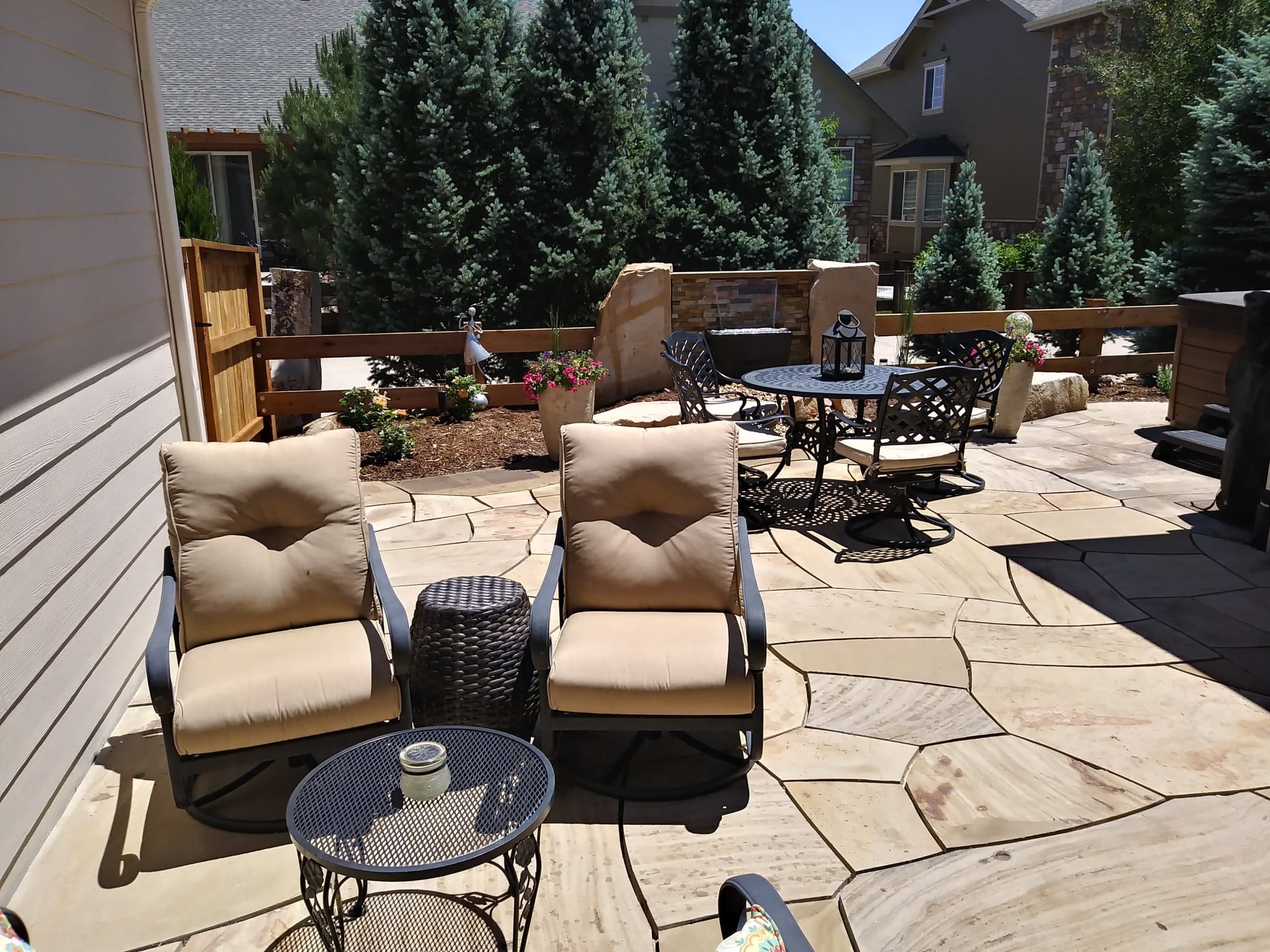 Flat stone patio with seating area.