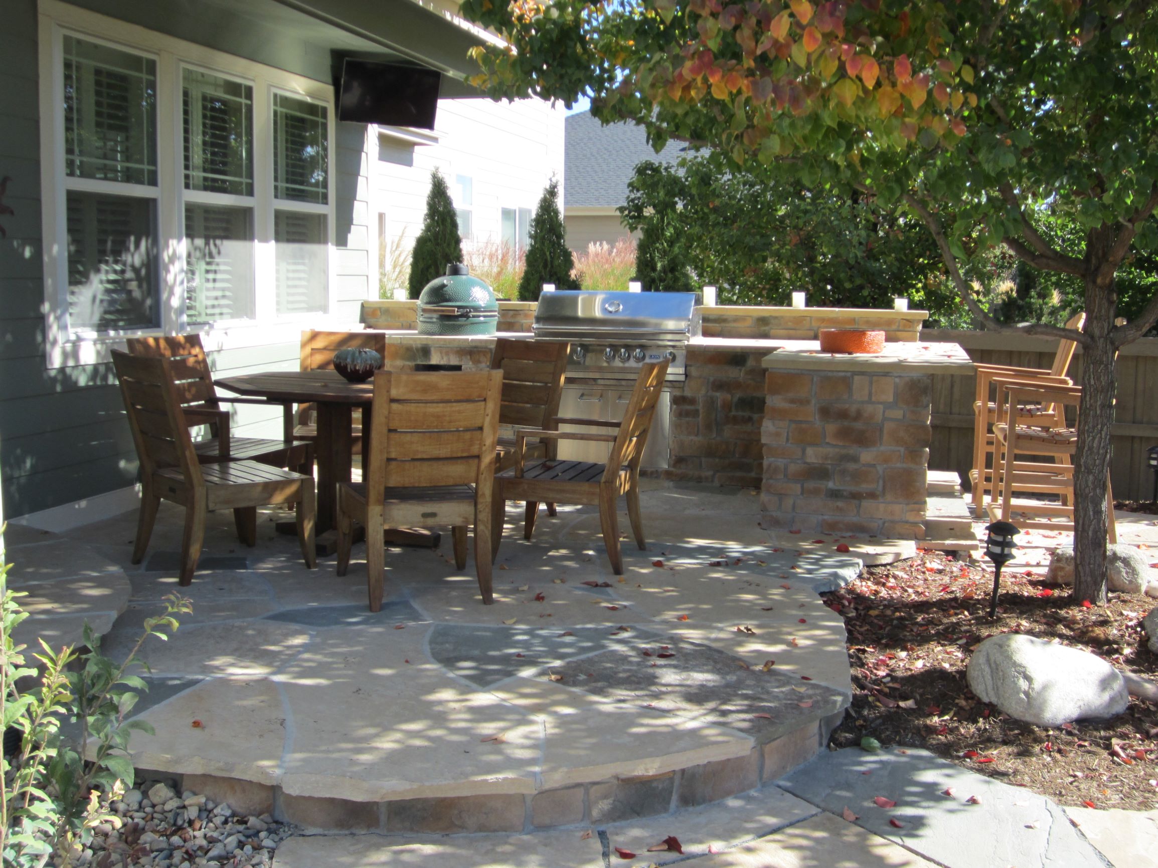 Flat stone patio with built in grilling station, and stone counter tops.